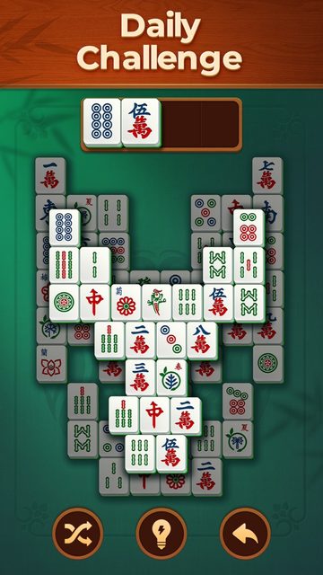 Vita Mahjong on iPhone showing the Daily Challenge board with the shuffle, hint and undo buttons